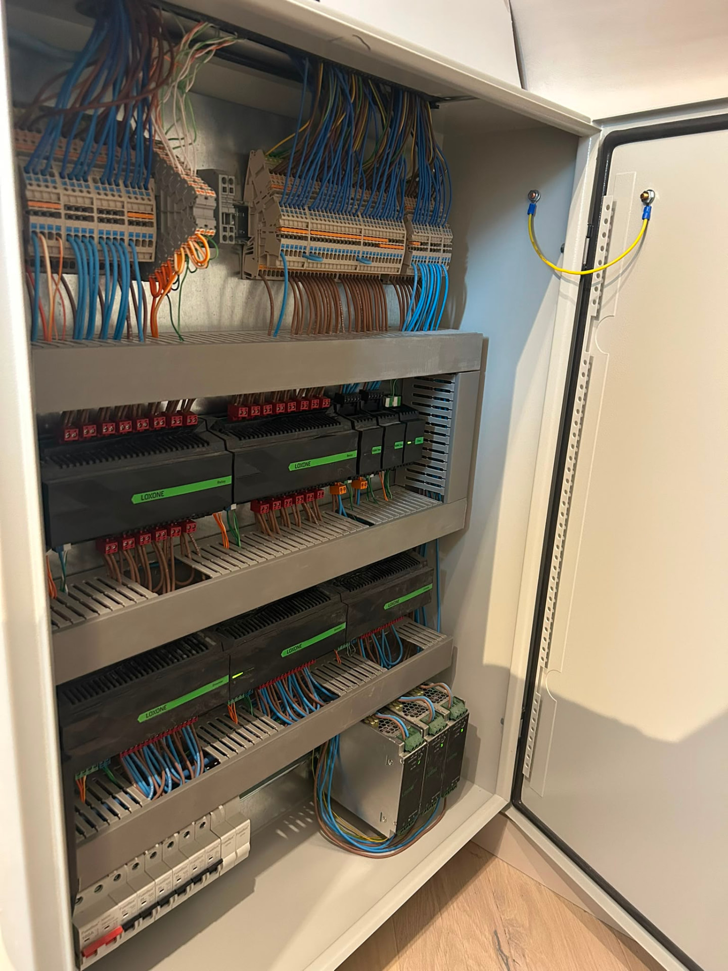 Loxone automation panel with neatly wired controller and extension modules