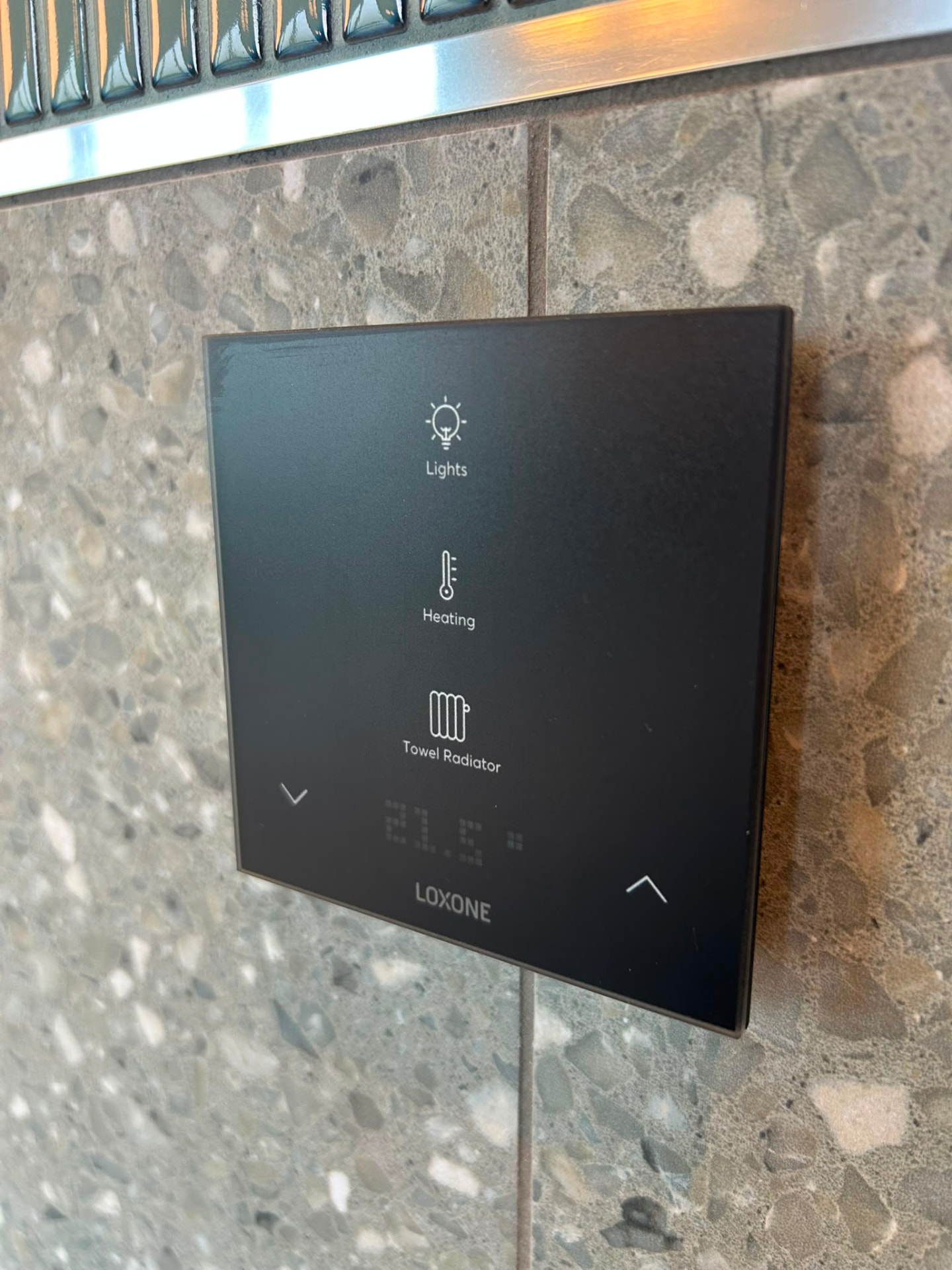 Loxone Touch wall switch controlling lighting and heating in a smart home
