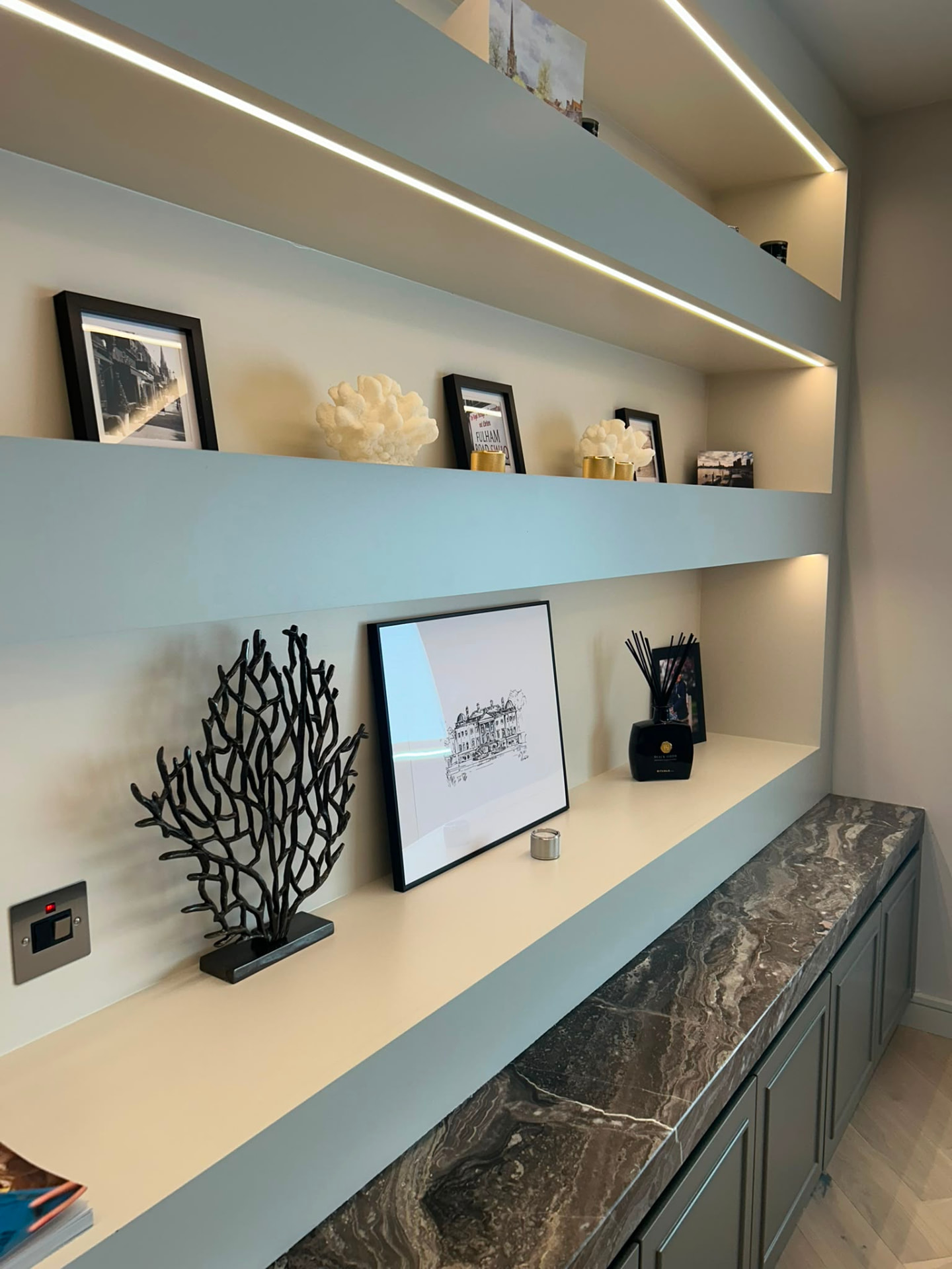 Integrated LED shelf lighting in a modern living area