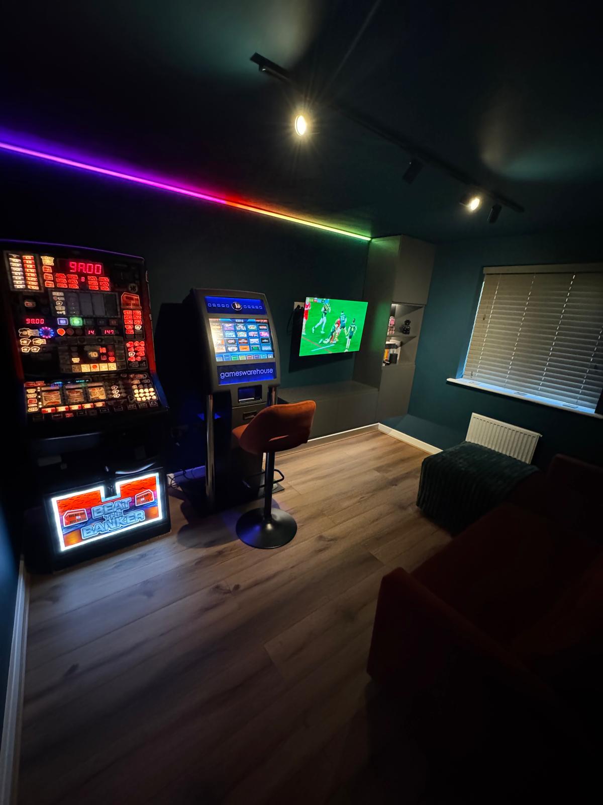 Entertainment room with colour-changing LED strip lighting and track spotlights